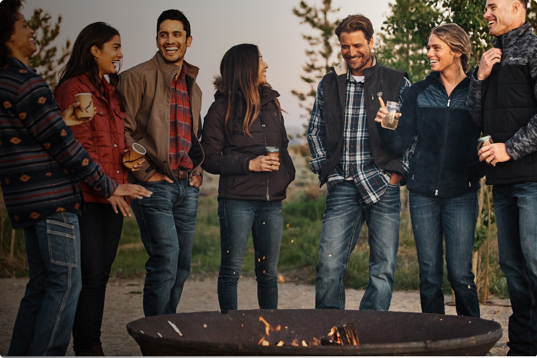 people standing by a fire outside